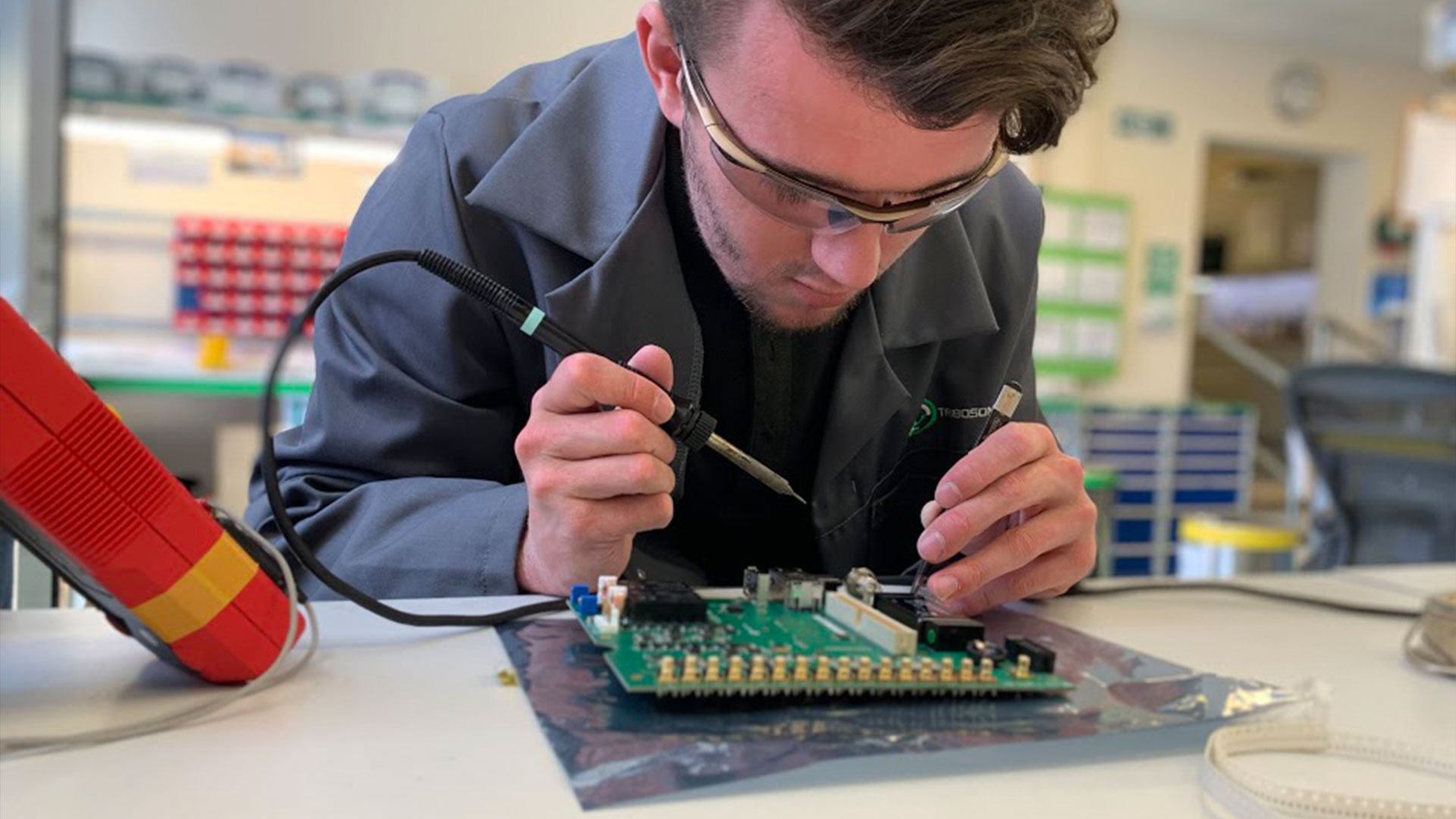 Tribosonics trainee engineer Will Morton (centre) with two fellow apprentices.